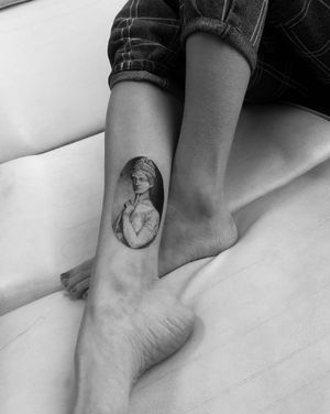 Blackwork lower leg tattoo by Maryna featuring a stunning illustrative design of a man statue