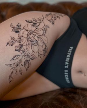 Beautiful blackwork flower tattoo by Liliia, a stunning addition to the upper leg. Get inspired!