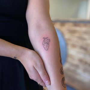 Elegant and detailed heart design on forearm by talented artist Liliia, perfect for a minimalistic yet impactful look.