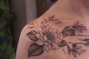 Beautiful blackwork flower design by Liliia on the shoulder, combining ornamental and illustrative elements.