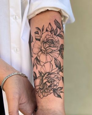 A stunning blackwork tattoo of a beautifully detailed flower on the forearm, done by the talented artist Liliia.