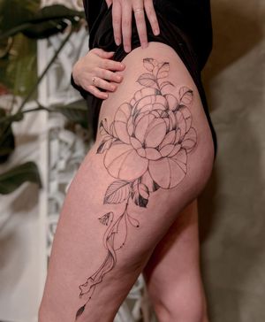 Elegant blackwork and fine line flower design by Liliia, perfect for the upper leg placement.