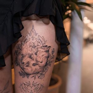 Admire the detailed blackwork fox and flower design on your upper leg, expertly crafted by Liliia.
