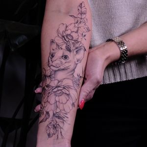 Illustrative tattoo by Liliia featuring a cat and flower motif in bold blackwork style. Perfect for cat lovers and nature enthusiasts.