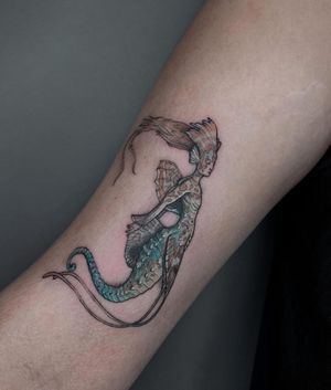 Capture the magic of the sea with this intricate forearm tattoo by artist Maryna featuring a seahorse, mermaid, woman, and wings in a stunning illustrative style.
