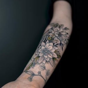 A stunning blackwork and illustrative tattoo of a beautiful ornamental flower, expertly done by Liliia on the forearm.