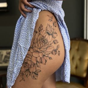 Get a stunning blackwork tattoo of a beautiful flower design on your upper leg by the talented artist Liliia.