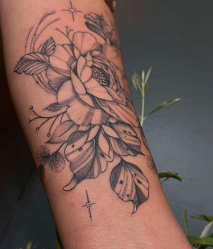 Beautiful blackwork flower tattoo on forearm by Liliia, with intricate details and bold lines.
