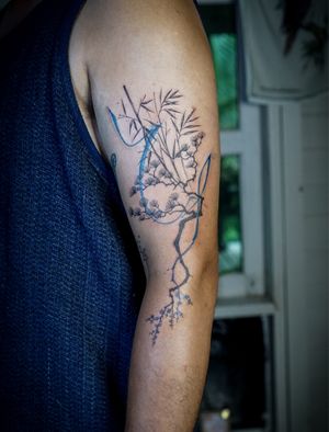 Asian botanical tattoo with abstract flow by a tattooist in Chiang Mai, Thailand