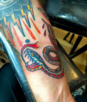 Get a timeless traditional tattoo with bold lines and vibrant colors by the talented flashbyaj.