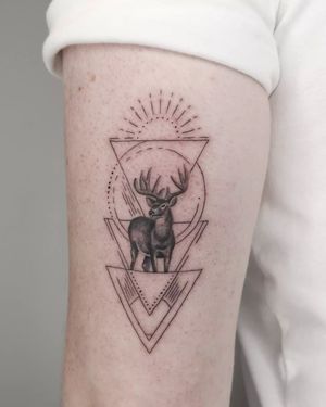 Elegantly designed fine line tattoo by George Francis features a geometric deer motif with intricate patterns on the upper arm.