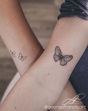 Get mesmerized by George Francis' blackwork butterfly design on your arm. Embrace the beauty of nature with this stunning tattoo.