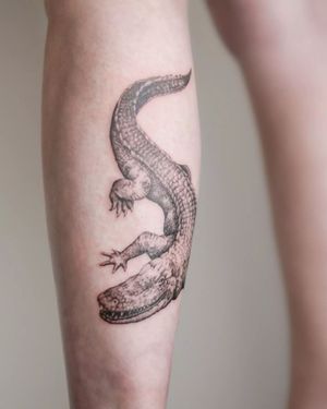 Get ready to make a bold statement with this striking blackwork illustrative tattoo of an alligator by artist George Francis.