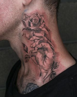 Check out this stunning blackwork illustrative tattoo of a flower and hand on the neck by Angel Chavez! Unique and bold.