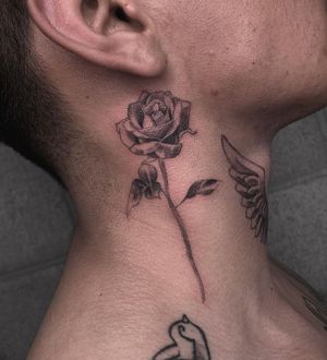 Blackwork floral design by Angel Chavez, beautifying your neckline with intricate details and bold outlines.