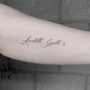 Get a unique upper arm tattoo by Angel Chavez featuring your favorite name or quote in a stylish illustrative style.