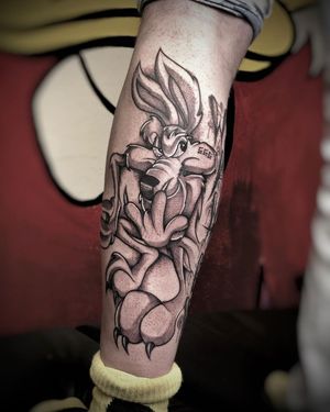 A stunning blackwork coyote tattoo on the lower leg, expertly done by tattoo artist Ruslan. Embrace your wild side with this unique design.