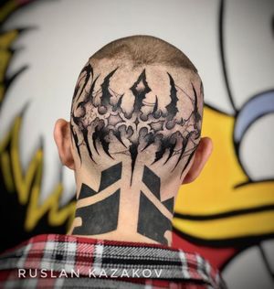 Let Ruslan create a unique blackwork tribal pattern design on your neck, combining lettering and illustrative elements for a bold statement.
