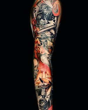 Illustrative black and gray sleeve tattoo featuring a skull, card, casino, and car motifs by Mika.