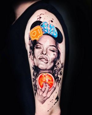 Capture the vibrant beauty of a woman holding an orange in stunning realism on your upper arm. Designed by Mika.