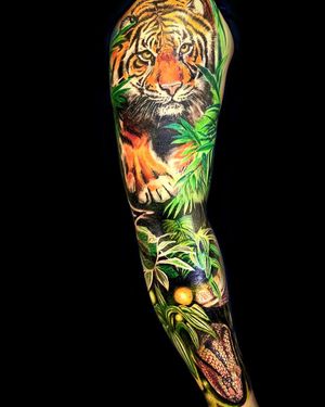 Vibrant neo-traditional tiger with realistic flowers and leaves, skillfully done by Mika on a sleeve.
