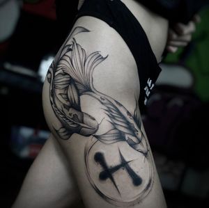 Impressive blackwork koi fish tattoo by Ruslan, beautifully designed for upper leg placement.