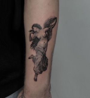 A stunning blackwork and realistic tattoo of an angelic girl with intricate wings, beautifully crafted by Toma on the upper arm.
