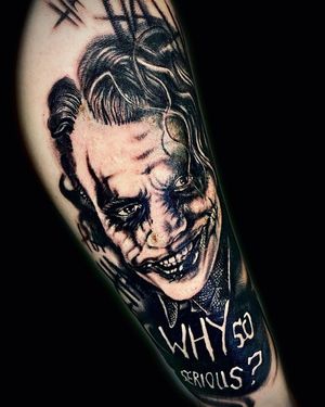 Unique blackwork tattoo featuring Heath Ledger's Joker with illustrative lettering quote by tattoo artist Mika.