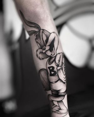 A unique blackwork tattoo of a cute bunny playing basketball, expertly crafted by Ruslan on the forearm.