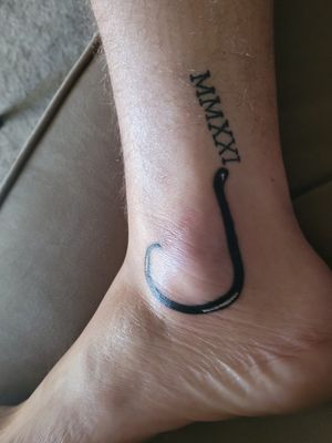 Not a great tat but it's a circle hook with the year 2021 above it