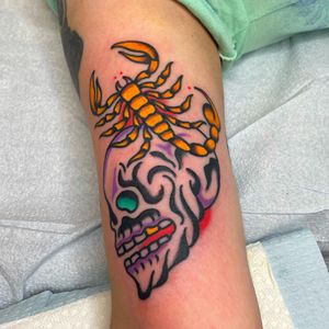 Vibrant and detailed upper arm tattoo featuring a fierce scorpion and skull design by Nick Osbourn. Perfect for those who appreciate traditional and illustrative styles.