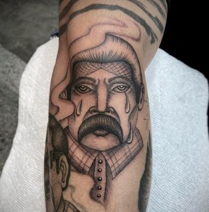 Unique black and gray design by Sasha Ignarski, depicting a man with tears on arm.