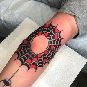 Ornamental spider web design by Nick Osbourn for a classic arm tattoo.
