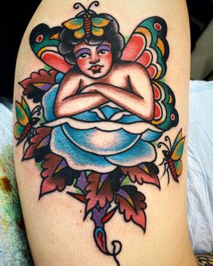 Beautiful tattoo featuring a woman, girl, butterfly, and flower on the lower leg. Done by Philip LaRocca in traditional style.