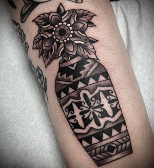 Beautiful black and gray arm tattoo featuring a traditional floral vase design with intricate patterns and mandalas.