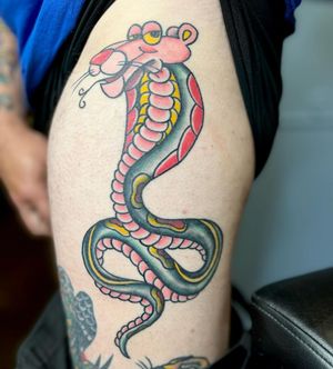 Vibrant and detailed upper leg tattoo featuring a snake and panther design by Kat Freedman. Illustrative style.