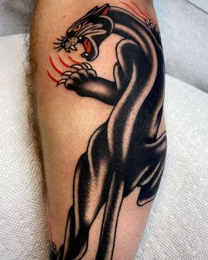 Get a fierce and timeless Panther tattoo on your lower leg, expertly done by Sasha Ignarski in traditional style.