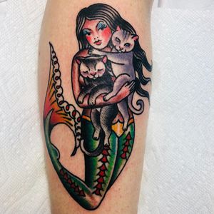 Beautiful forearm tattoo by Jason Fancher blending cat, mermaid, and woman motifs in a neo-traditional, illustrative style.