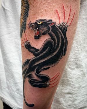 Get a fierce and classic panther tattoo by artist Philip LaRocca, perfect for your lower leg. Embrace the wild side!