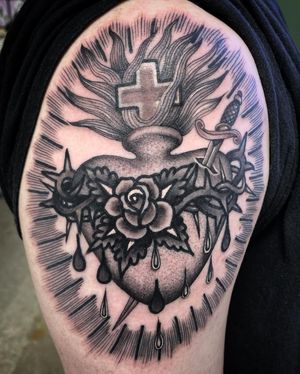 A striking black and gray design by Philip LaRocca featuring a heart, sword, cross, thorns, and tears for a dramatic look.