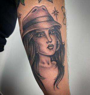 Unique blackwork piece by Sasha Ignarski featuring a stylish woman with hat and earrings.