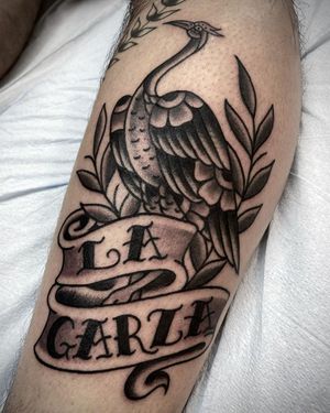 This blackwork tattoo features a beautiful heron and a meaningful quote, skillfully done by Sasha Ignarski on the arm.