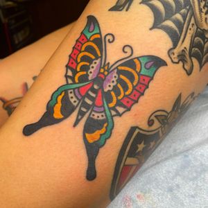 Get a stunning traditional butterfly tattoo on your lower leg by talented artist Nick Osbourn. Visit us to book your appointment today!