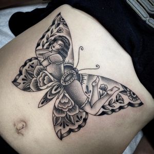 Blackwork design by Sasha Ignarski featuring a beautiful butterfly and woman illustration on the stomach area.