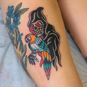 Illustrative traditional tattoo on lower leg featuring a striking bird merged with death imagery by Nick Osbourn.
