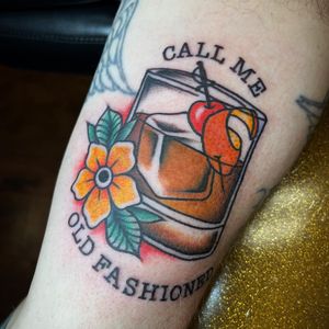 Unique arm tattoo by Kat Freedman featuring flowers, whisky glass, and a meaningful quote
