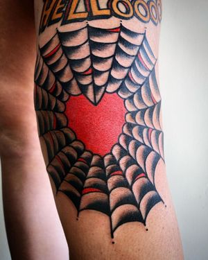 Capture the essence of love and danger with this stunning traditional tattoo by Philip LaRocca. Featuring a spider, heart, and spider web motif on the arm.