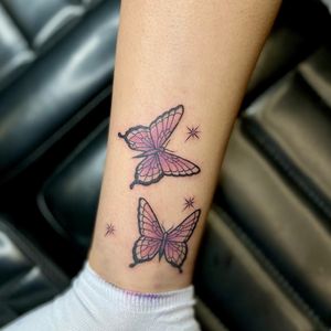 A beautifully detailed neo-traditional butterfly tattoo on the lower leg, created by Kat Freedman. An illustrative piece full of vibrant colors and intricate linework.