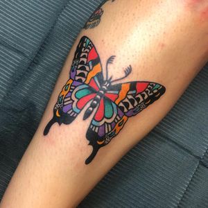 Traditional style butterfly tattoo on shin by Nick Osbourn, featuring detailed illustration work.