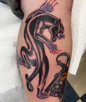 Get inked by Jason Fancher with an illustrative traditional panther design on your lower leg.